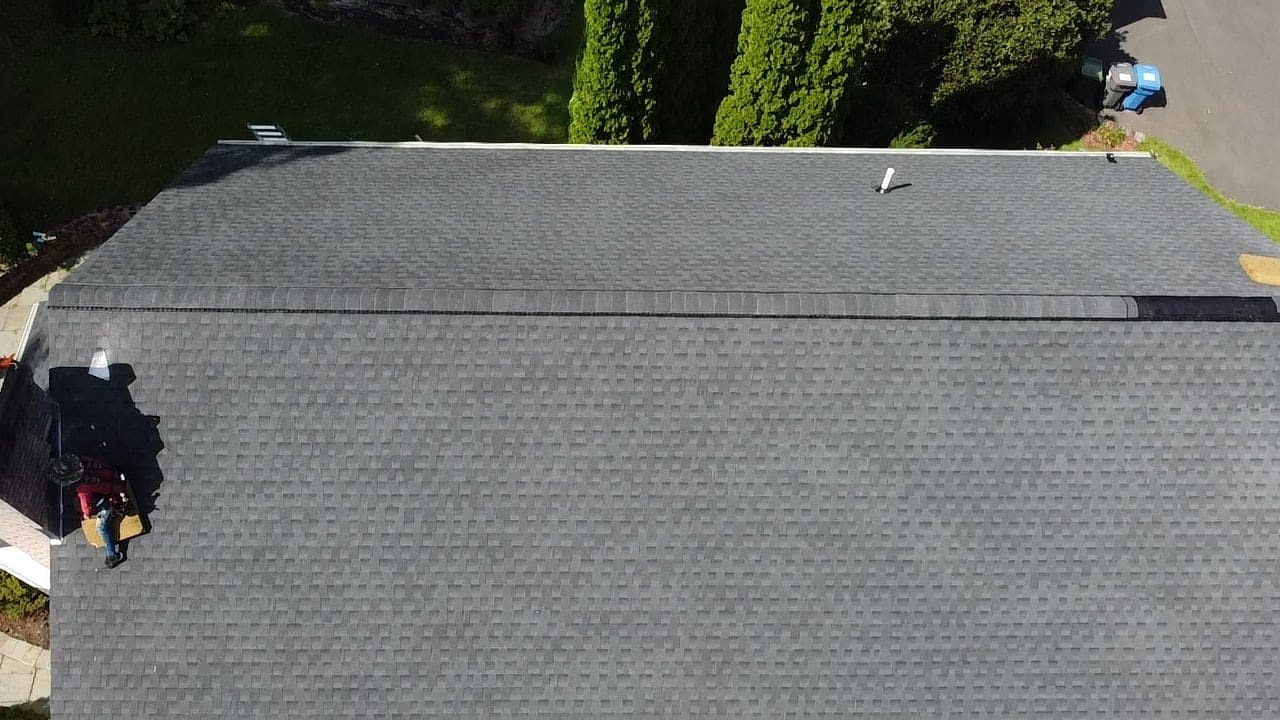 Aerial view of a clean, finished gray shingle roof