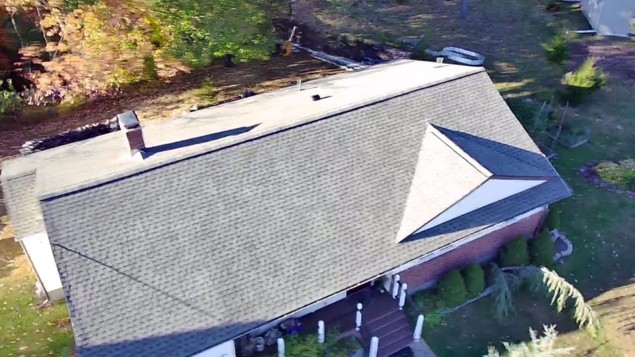 Aerial view of a finished hip roof with new architectural shingles