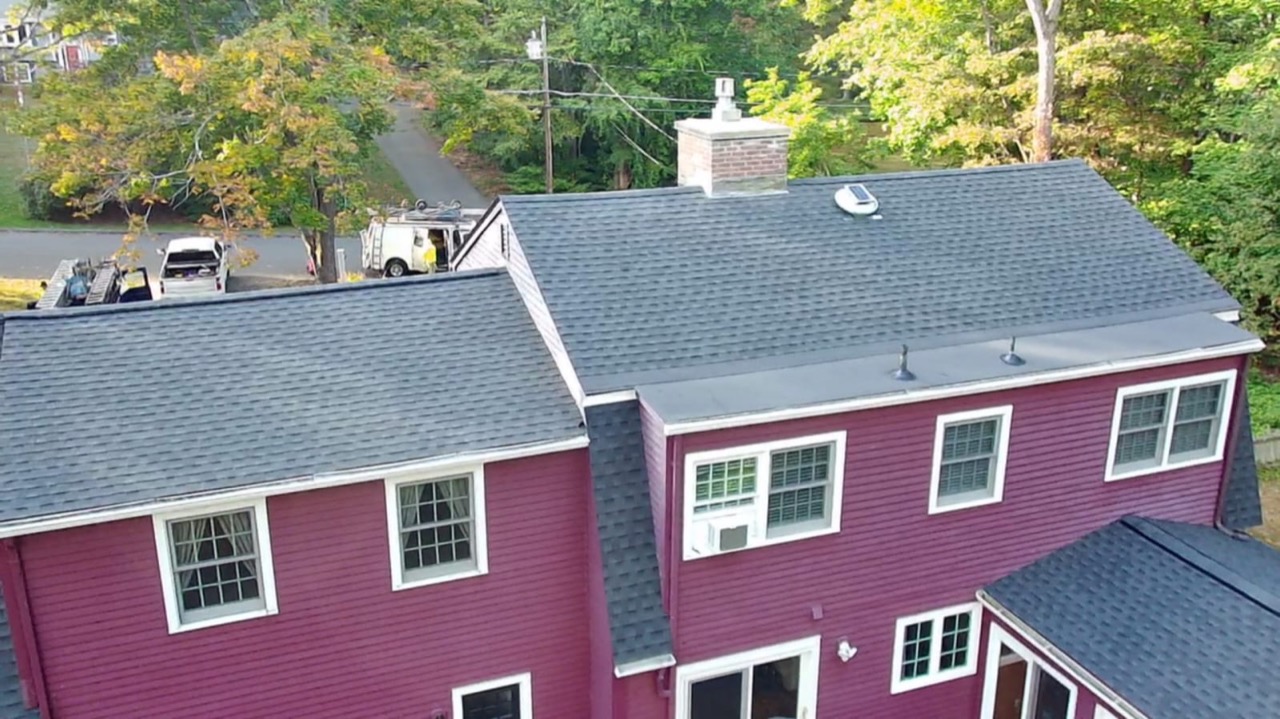 Aerial street view of a finished roof on a red house